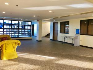 a room with a yellow chair and a table in a building at La Primera Grande Beach Resort in Roxas +37 photos