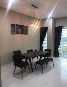 a dining room with a table and chairs at Ipoh Water Front City Homestay in Ipoh