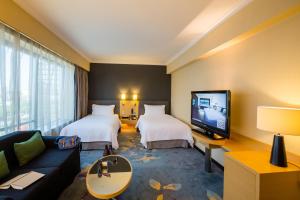 a hotel room with two beds and a tv at pentahotel Beijing in Beijing