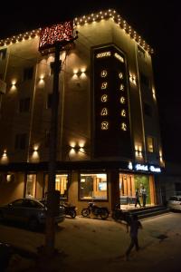 a sign on the side of a building at night at Hotel Oscar in Amritsar