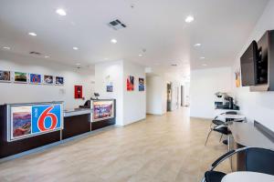 a waiting room with a large tv on a wall at Motel 6-Channelview, TX in Channelview