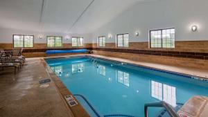 a large swimming pool with blue water in a building at Best Western Hampshire Inn & Suites in Seabrook