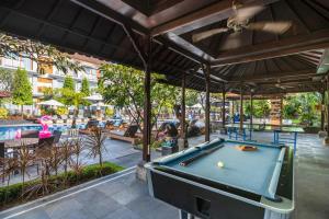 a pool table under a pavilion at a restaurant at Kuta Beach Club Hotel in Kuta