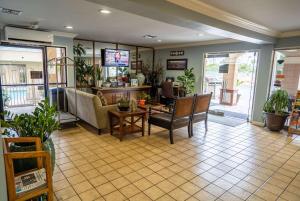 a living room with a couch and a table at Howard Johnson by Wyndham Buena Park in Buena Park