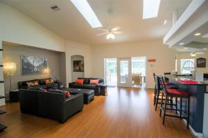 a living room with couches and a bar at Luxury 4BR Pool Home with Jacuzzi- Inverness in Inverness