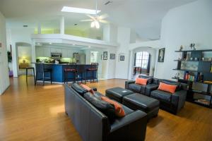 a living room with two couches and a kitchen at Luxury 4BR Pool Home with Jacuzzi- Inverness in Inverness