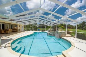 an indoor swimming pool with a large glass ceiling at Luxury 4BR Pool Home with Jacuzzi- Inverness in Inverness