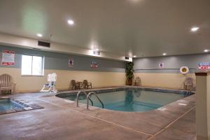 a large swimming pool in a large room with at Quality Inn & Suites in Watertown