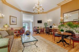 a living room filled with furniture and a fireplace at The Carriage House Inn Newport in Middletown