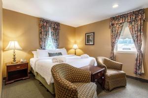 En eller flere senge i et værelse på Traditions Hotel & Spa, Ascend Hotel Collection