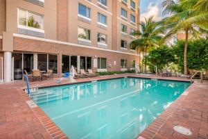 a large swimming pool in front of a building at Cambria Hotel Ft Lauderdale, Airport South & Cruise Port in Dania Beach