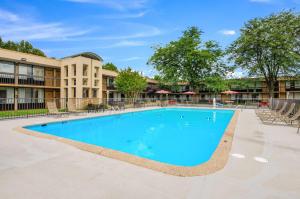 a large swimming pool in front of a building at Quality Inn Roanoke Airport in Roanoke