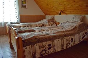 A bed or beds in a room at Tündérfátyol vendégház
