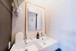 a bathroom with a white sink and a mirror at Hotel Pagoda in Nara