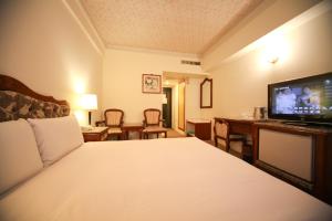Postelja oz. postelje v sobi nastanitve Hua Tong Hotel