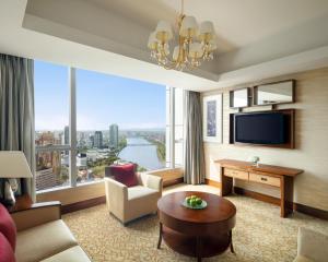 a living room with a large room with a large window at Shangri-La Ningbo in Ningbo