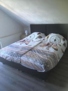 a bed with a comforter and pillows on it at Gretel von Birne in Winterberg