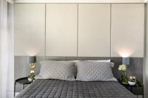a white bed with a white bedspread and pillows at The Bowral Hotel in Bowral