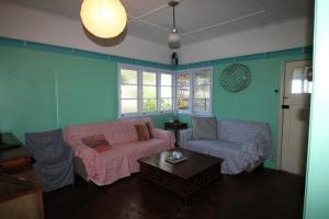 a living room with a couch and a table at Signal Cottage in Cowan Cowan