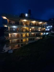 an apartment building at night with lights on at Hotel Valley View Inn in Nagarkot