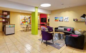 a living room with a couch and chairs and a table at Mizpe Yam Boutique Hotel in Netanya
