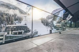 a view of a cruise ship through a window at Elizabeth Arthotel in Ischgl