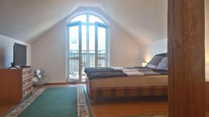 a bedroom with a bed and a tv and a window at Domus in Ustka