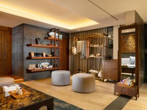 a living room with two stools and a table at Anantara Uluwatu Bali Resort in Uluwatu