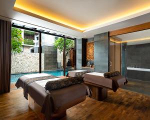 
a hotel room with a large bed and a large window at Anantara Uluwatu Bali Resort in Uluwatu
