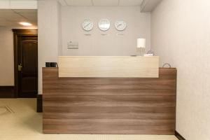 a reception desk with clocks on the wall at Boutique Hotel on Mukomolniy in Moscow
