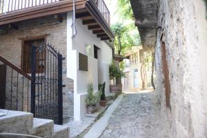 a stone alley with a gate and a building at Crambero Suites in Alona