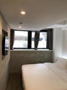 a bedroom with a bed and a television in it at Homy Central in Hong Kong
