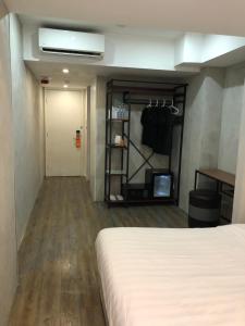 a hotel room with a bed and a closet at Homy Central in Hong Kong