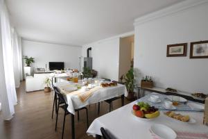 a dining room with tables and chairs with fruit on them at Pisacane61 B&B in Modena