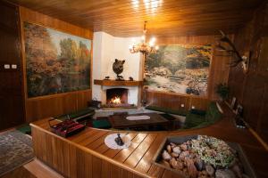 an overhead view of a living room with a fireplace at Kormos Residence in Brăduţ