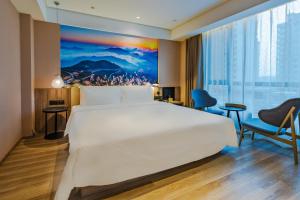 Postel nebo postele na pokoji v ubytování Atour Hotel (Wenzhou International Airport Olympic Sports Center)