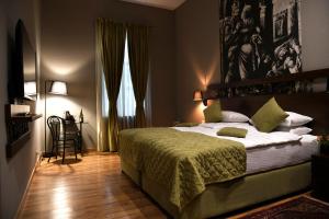 a bedroom with a bed and a lamp at Badagoni Boutique Hotel Rustaveli in Tbilisi City