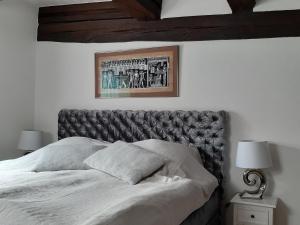a bed with a leather headboard in a bedroom at FeWo im Mesnerhaus Mengen in Mengen