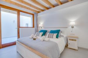 a white bedroom with a bed and a window at Urban Suites Palma - Turismo de Interior in Palma de Mallorca