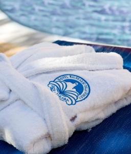 a towel with a logo on it sitting on a table at Hotel Balneario de La Virgen in Jaraba