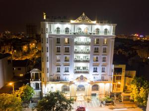 a large white building at night with lights at 3MG Lakeside Hotel in Hai Phong