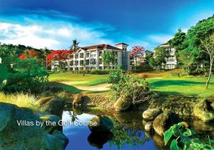 a view of a golf course with a house and a creek at Fairways and Bluewater Boracay in Boracay