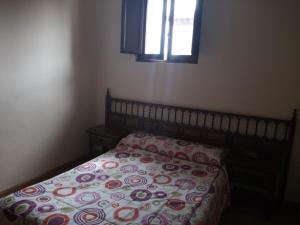 a bedroom with a bed with a pillow and a window at Hostal Galicia in Ribadeo