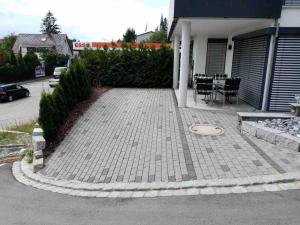 a patio in front of a house with a table and chairs at Ferienwohnung Angelina in Markdorf