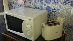 a microwave oven sitting on top of a table at DOMO TIA ROSINA (I.U.N. P3203) in Cuglieri