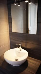 a white sink in a bathroom with a mirror at Paraporti in Chora Folegandros