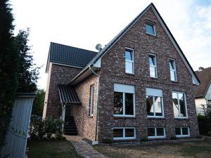 a brick house with a gambrel roof at Damm Apartments in Hannover