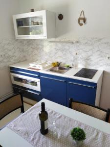 a kitchen with a table with a bottle of wine at Apartma Viktorija in Kranjska Gora
