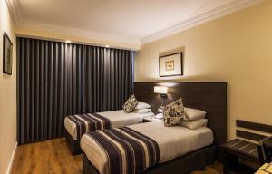 Voodi või voodid majutusasutuse Ambassador Hotel toas