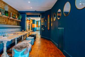 a restaurant with blue walls and blue chairs and tables at Mitre Hotel Manchester City Centre in Manchester
